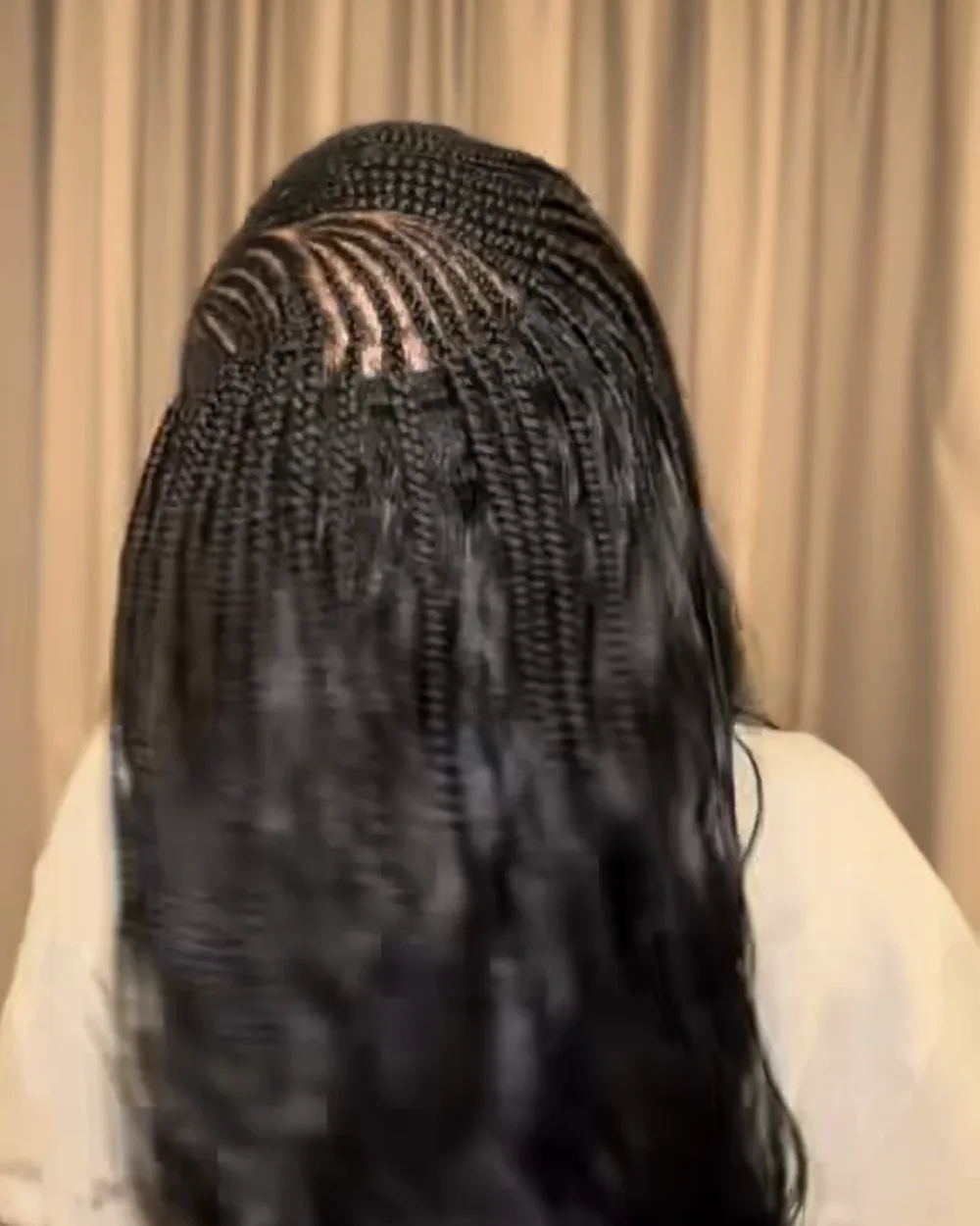 Fulani cornrow patterning at the front blended into a loose sew-in